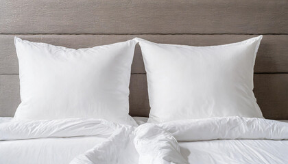 Fototapeta na wymiar White pillow on bed in bedroom closeup