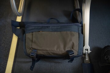 Passenger put a bag under the aircraft seat for safety flight