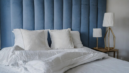 On a blue bed are white pillows, a duvet, and a duvet cover. On top of a blue sofa is a white bed. Bedroom mock up on the wall with a bed, bedding, and poster frame. looking left. - obrazy, fototapety, plakaty