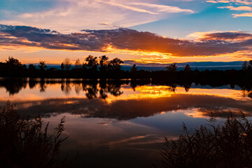 Summer sunset with reflections near Aholming, Deggendorf, Bavaria, Germany