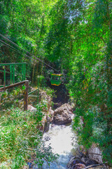 Unidentified tourists move in a cable car above Datanla waterfall