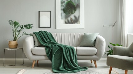 Light gray fabric three-seat modern sofa with gray and green pillows and plaid. - obrazy, fototapety, plakaty