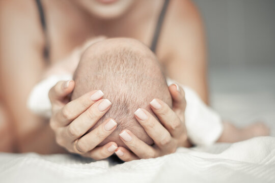 happy mother hugging her baby, maternal love and care, mother's day concept