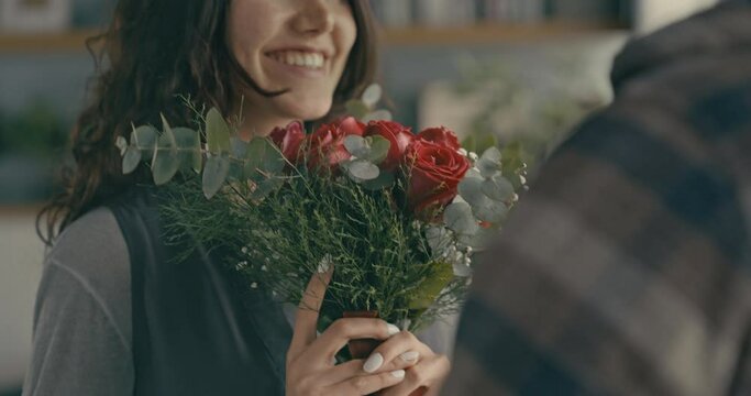 Young man gives a bouquet of roses to his girlfriend	

