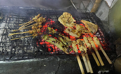 Charcoal grill with meat and vegetables in Bali