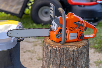Naklejka premium Petrol Powered Chainsaw at Wood Log Lumberjack Equipment