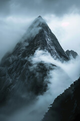Moody mountain peak shrouded in fog, suitable for travel or nature themes.