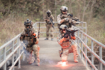 Soldiers in camouflage military uniforms carrying weapons, Reconnaissance missions in the tropical...
