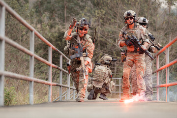 Soldiers in camouflage military uniforms carrying weapons, Reconnaissance missions in the tropical...