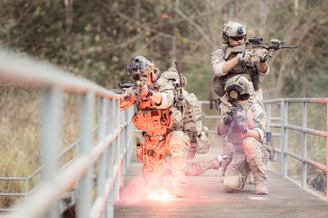 Soldiers in camouflage military uniforms carrying weapons, Reconnaissance missions in the tropical...