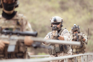 Soldiers in camouflage military uniforms carrying weapons, Reconnaissance missions in the tropical...