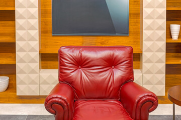 Leather Armchair and TV Screen at Wall