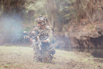 Soldiers in camouflage military uniforms carrying weapons, Reconnaissance missions in the tropical...