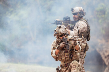 Soldiers in camouflage military uniforms carrying weapons, Reconnaissance missions in the tropical...