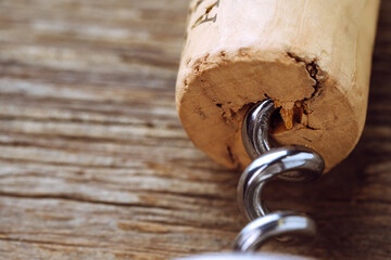 Close-up of wine cork and corkscrew on wooden table with copy space. Perfect for wine and...