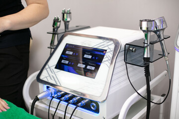 device for various massage tips, RF-lifting, vacuum-impulse massage, ultrasonic cavitation - obrazy, fototapety, plakaty