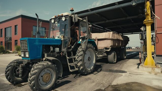 Tractor vehicle bringing the collected grapes from the farm to the vinery factory. Vinery tractor vehicle carrying lots of harvested crops. Vinery tractor vehicle transporting the seeds.