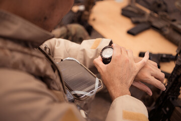 Group of soldiers in camouflage uniforms hold weapons in a field tent, Plan and prepare for combat training.