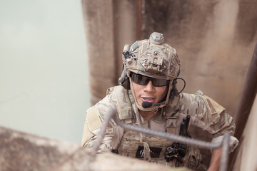 Soldiers in camouflage military uniforms carrying weapons, Reconnaissance missions in the tropical...