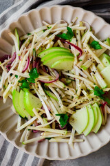 Apple celery root slaw in ceramic bowl. selective focus