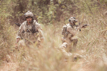 Soldiers in camouflage military uniforms carrying weapons, Reconnaissance missions in the tropical...