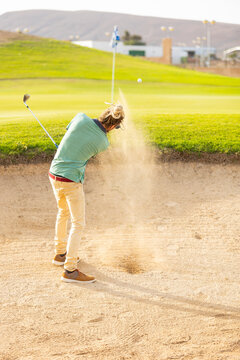 Unique Golfer with Dreadlocks Playing Sand Shot