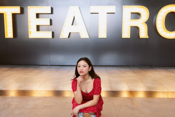 Introspective moment in front of theater lights