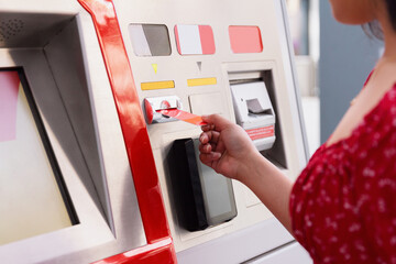 Woman withdrawing cash from an ATM machine