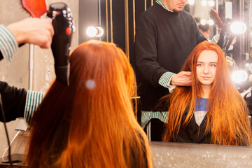 Hairstylist working on client's hair in salon