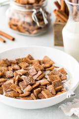 A bowl of cinnamon toast crunchy cereal with milk, ready for eating.