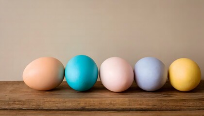 easter eggs on a wooden table with a warm neutral background - copy text space