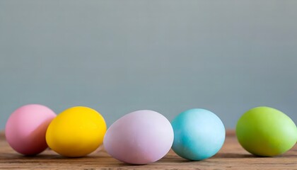 easter eggs on a wooden table with a cool neutral background - copy text space