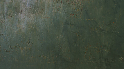 Wall surface texture with peeling green paint.