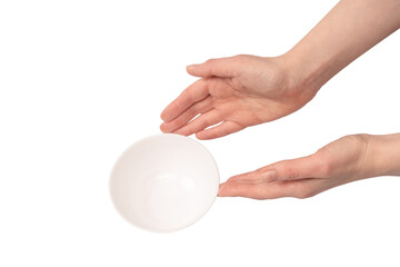 Female hand is holding a ceramic bowl isolated on white background.