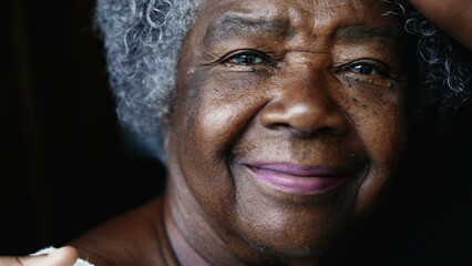 joyful South American elderly black lady in 80s depicting wisdom wrinkles in old age. Gray-hair...