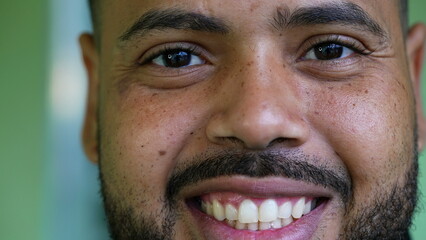 Macro close-up portrait of a hispanic black latin man smiling at camera. Tight closeup of South...