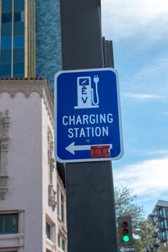 Blue and white EV charging station directional sign in downtown Tucson AZ