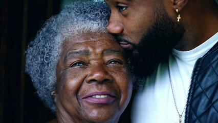 Young African American Grandson with Elderly Grandmother, Close-up of Two Generational Faces contrasting ages. Family embrace