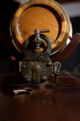Concept of a Locked Liquor Barrel with the opportunity to open it with the key on the table