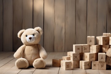 A teddy bear in childrens room on wooden floor next to the scattered cubes for games of toddlers