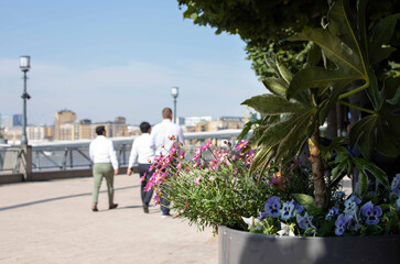 Office workers stroll on the riverside path near Canary Wharf