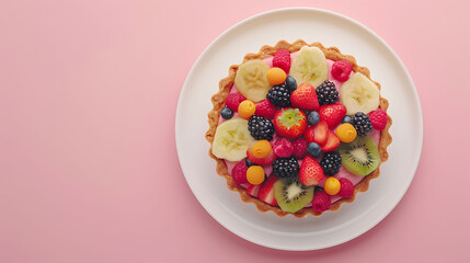 Fruit tart with kiwi, strawberries, and raspberries on a white plate, top view with copy space....