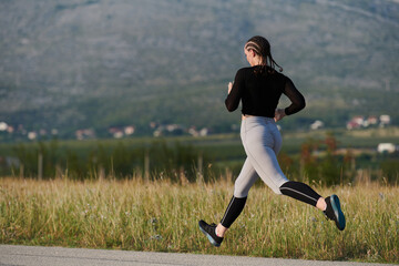 Naklejka premium Solo Stride: Determined Athlete Woman Embarks on Fitness Journey for Marathon Preparation.