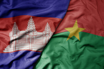 big waving national colorful flag of burkina faso and national flag of cambodia.