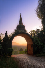 Temple gate (Phutthawadee arch) of Khao Na Nai Luang Dharma Park at sunrise, Surat Thani, Thailand