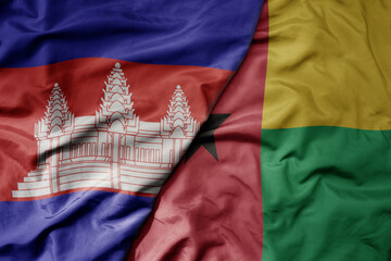big waving national colorful flag of guinea bissau and national flag of cambodia.