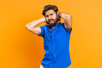 Dont want to hear and listen. Frustrated annoyed irritated man covering ears gesturing No, avoiding advice ignoring unpleasant noise loud voices. Middle eastern guy isolated alone on orange background - obrazy, fototapety, plakaty