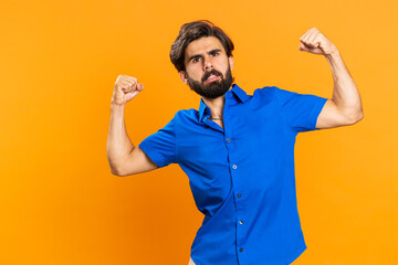 I am strong and independent. Young man showing biceps and looking confident, feeling power strength...