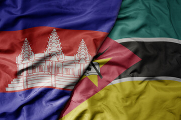 big waving national colorful flag of mozambique and national flag of cambodia.
