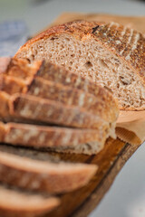 Closeup with selective focus of freshly baked rye bread being cut